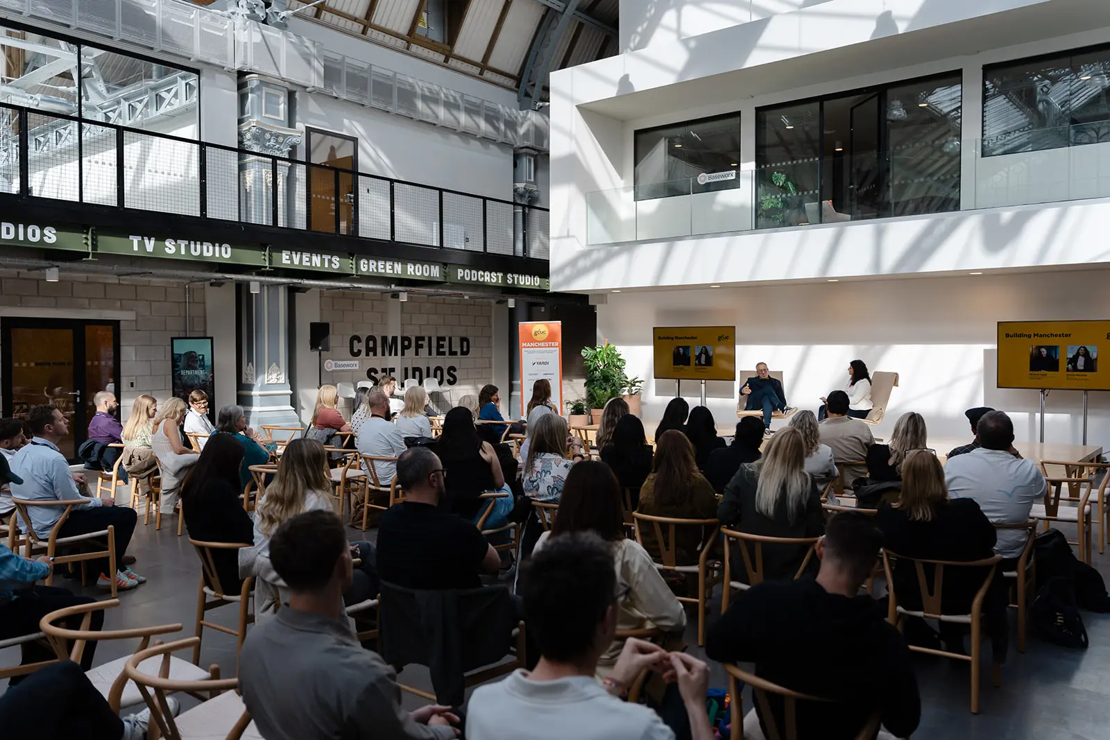 A full room of operators seated for a panel session at Campfield Studios.