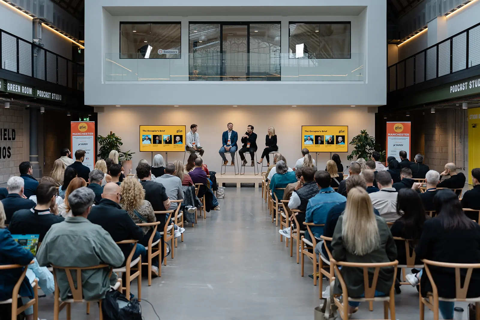 GCUC Manchester panel audience in a daylit atrium