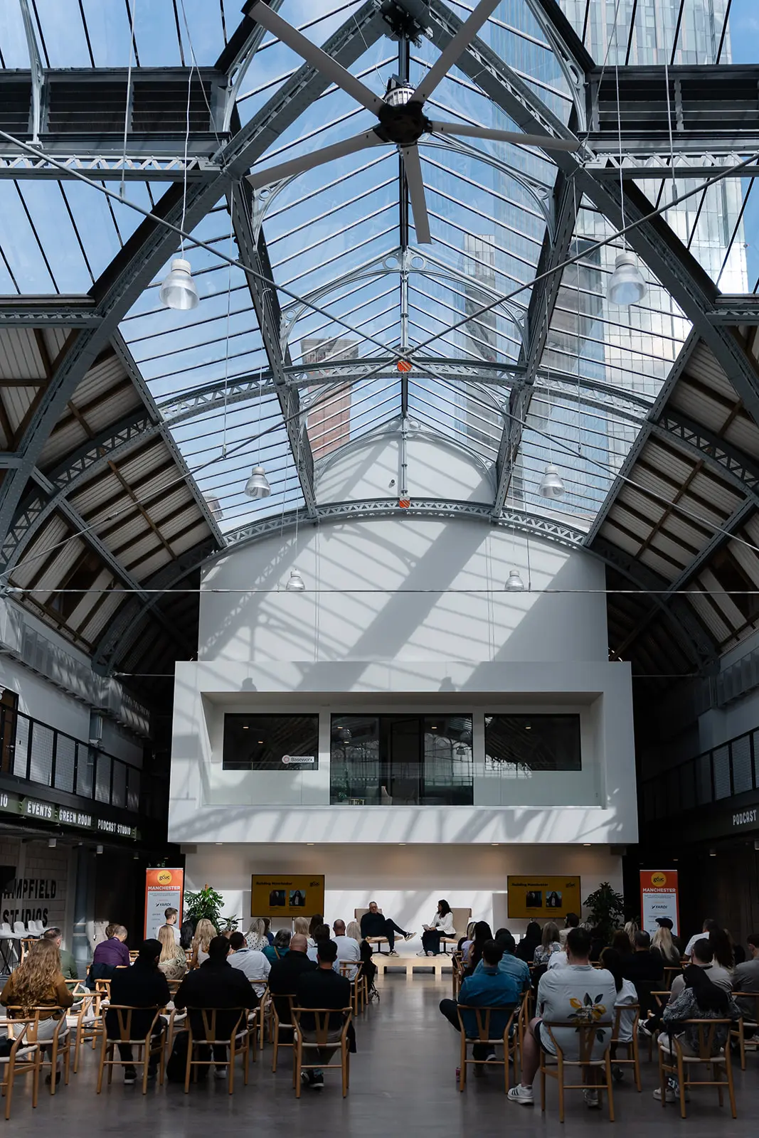 The glass roof of Campfield Studios above a seated audience.