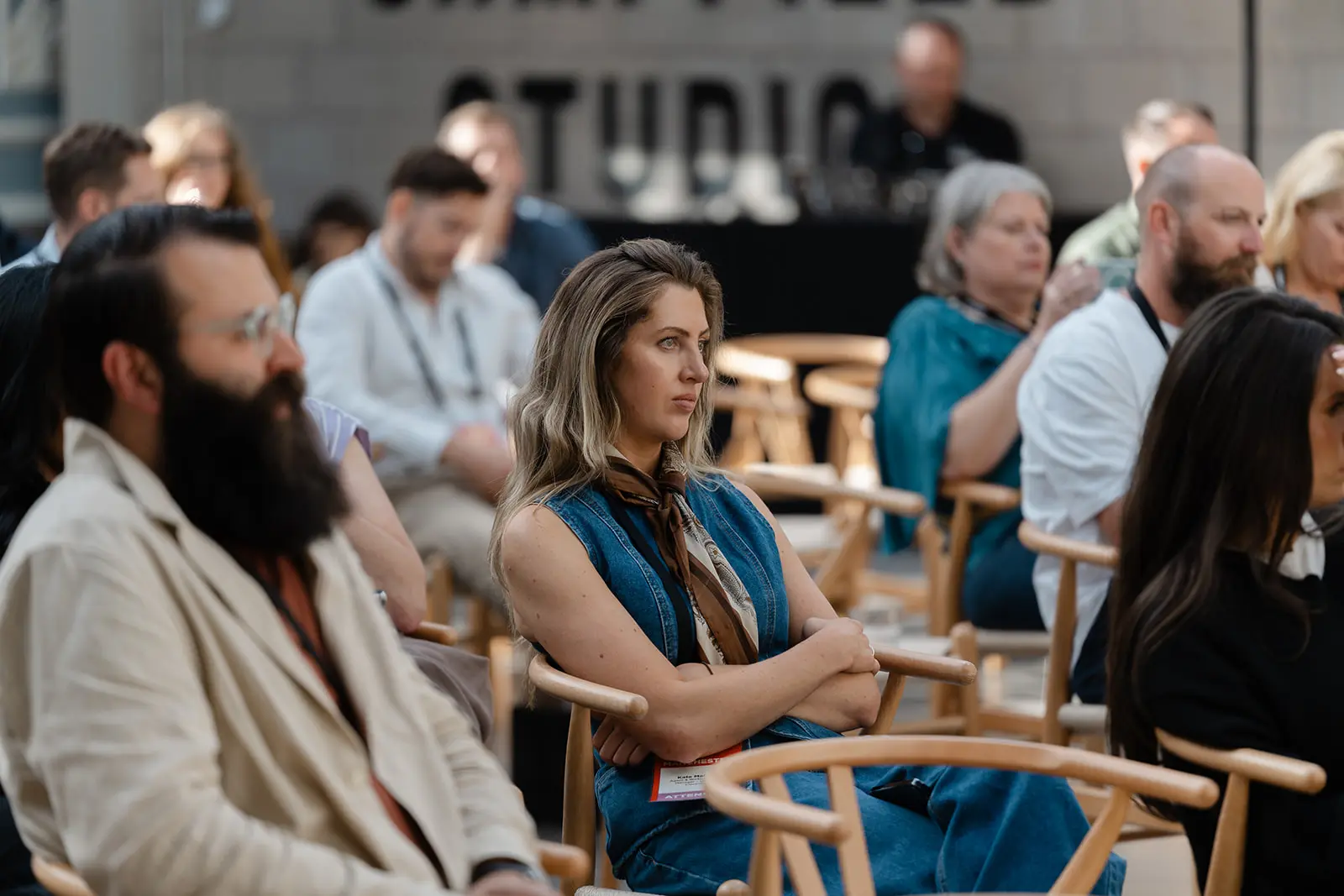 An operator in a seated audience following a session closely.